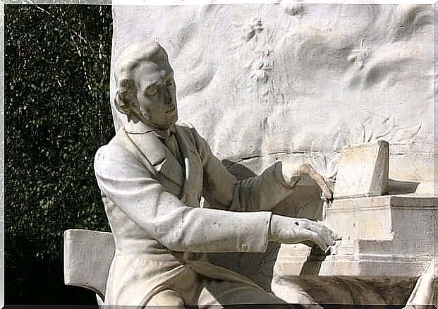 A statue of Chopin playing the piano