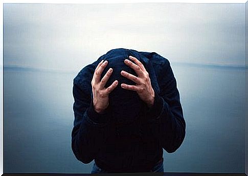 man holding his head in his hands